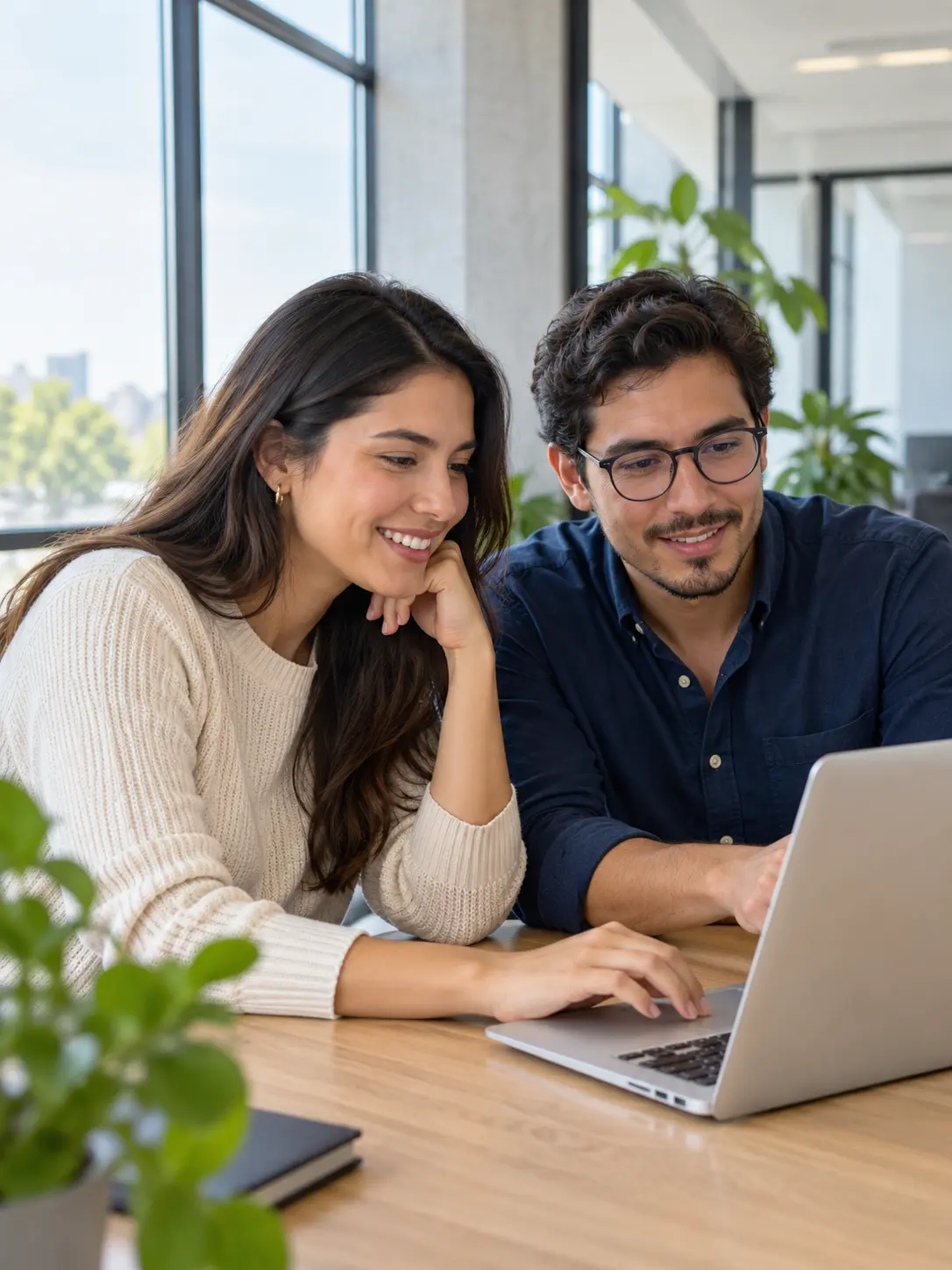 Two professionals collaborating on a laptop